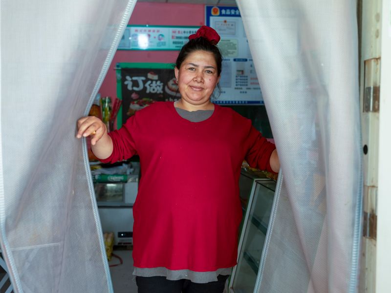 © Pan Wang - The female owner of a small supermarket.in Qiemo Ancient City, Xinjiang Uygur Autonomous Region, China, May 23, 2025.