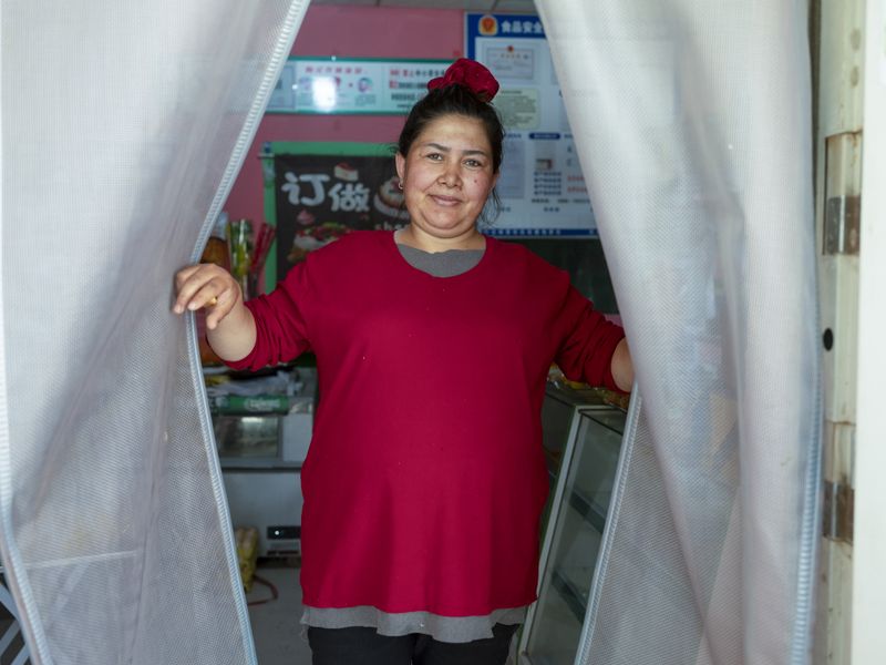 © Pan Wang - The female owner of a small supermarket.in Qiemo Ancient City, Xinjiang Uygur Autonomous Region, China, May 23, 2025.