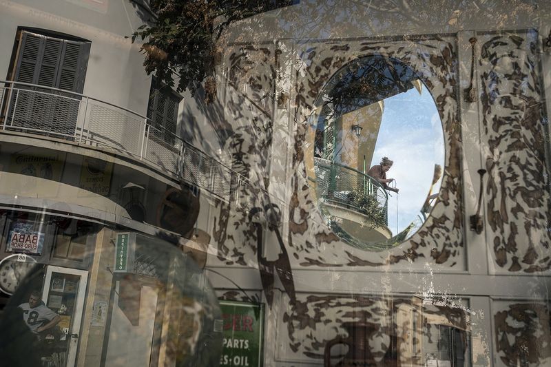 © Sahan Nuhoglu - An old Greek Cypriot woman is reflected on a retro decoration shop window based in Nicosia, Cyprus.