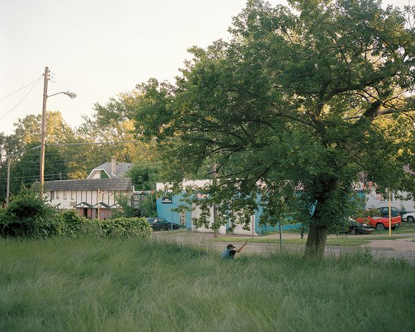 © Juan Madrid - A homeless man waves to a passing car.