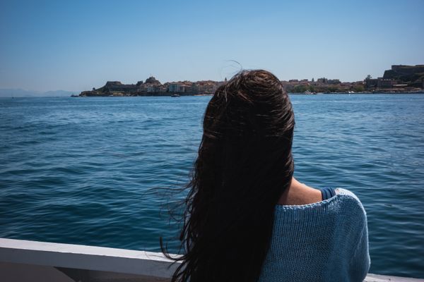 © Christopher Jones - Woman on ferryIonian Sea.A passenger watches Corfu from the ferry as it approaches the island.