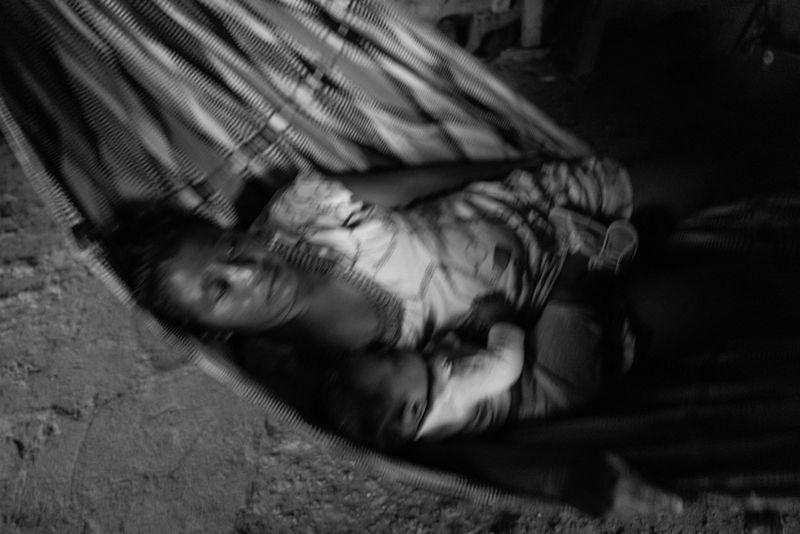 © Fernanda Pineda - Ernelda is in charge of the house, here she rocks her baby in the hammock in which they sleep.
