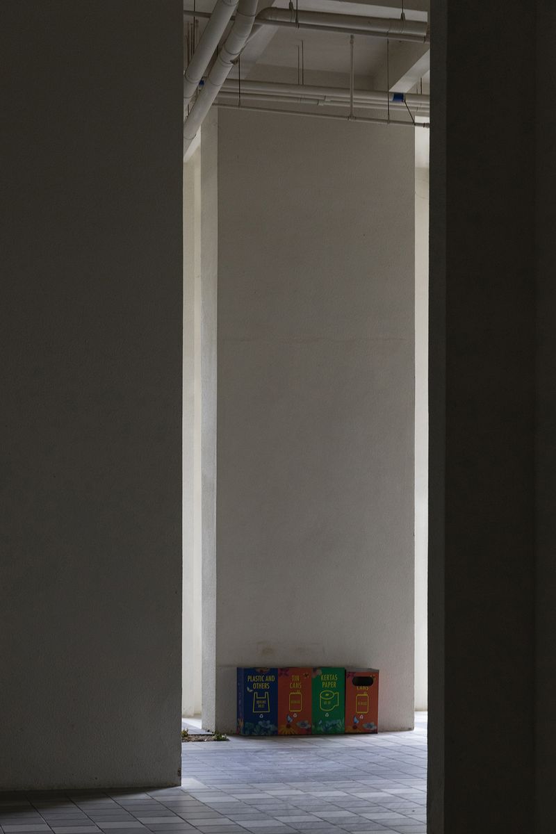 © Francesca Pompei - Waste sorting-rubbish bins in a corner of a deserted condominium.