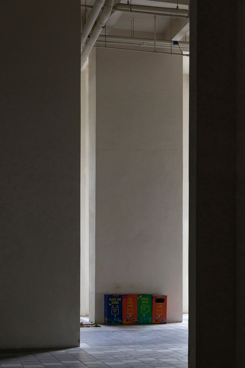 © Francesca Pompei - Waste sorting-rubbish bins in a corner of a deserted condominium.