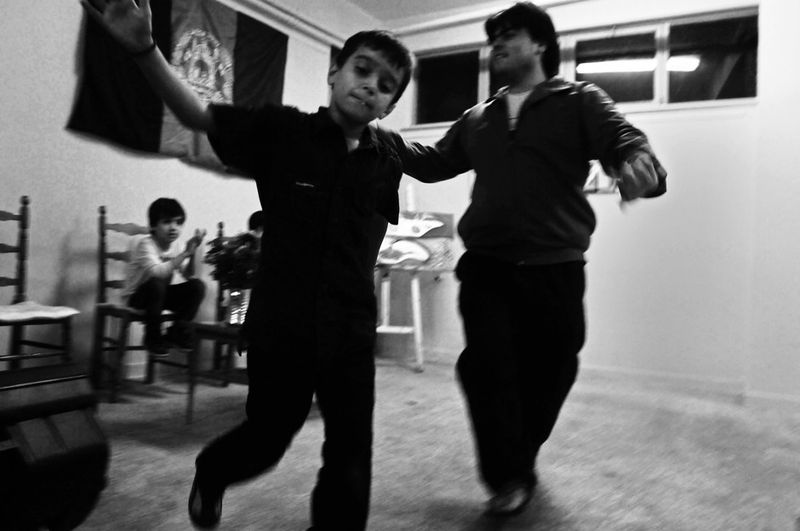 © Stephen Boyle - Afghan migrants performing traditional dance while celebrating Eid al Adha in Athens in October 2012.