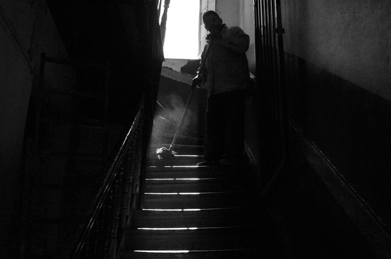 © Stephen Boyle - Somali migrant cleaning up after a police raid on the Somali Centre the previous night. March 2012