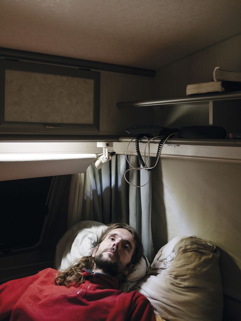 © Nick Somers - 'R' in the caravan where he now lives after having to flee from his home.