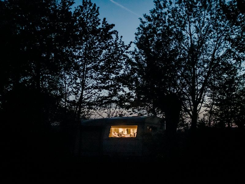 © Nick Somers - 'R' in the caravan where he now lives after having to flee from his home.