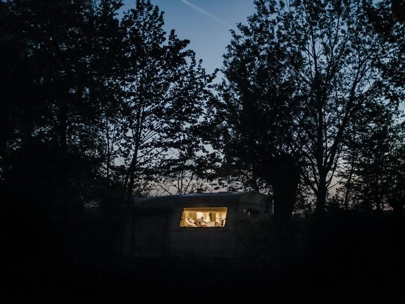 © Nick Somers - 'R' in the caravan where he now lives after having to flee from his home.
