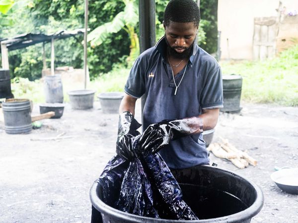 © Adegoke Kolawole - At the VatA dyer works cloth by hand inside an open dye vat, Abeokuta, 2025.