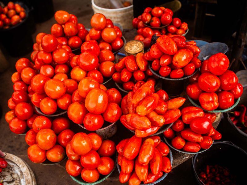 © Adegoke Kolawole - Red BowlsTomatoes and tatashe peppers arranged in metal bowls as units of trade, Bodija Market, Ibadan,2025