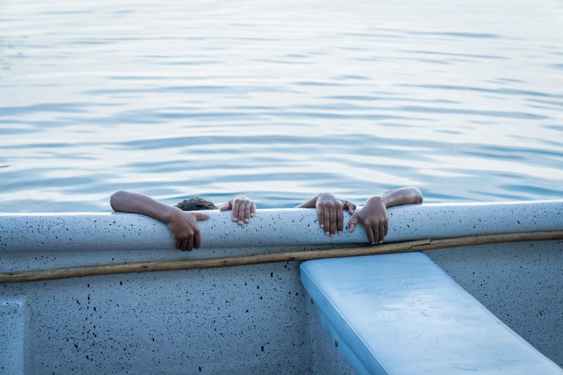 © Gaston Zilberman - The boat is the island's most valuable asset. Two children hold on to the edge of one.
