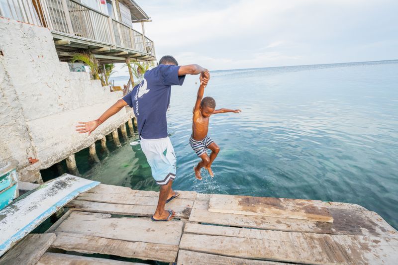 © Gaston Zilberman - José Javier grabs his son out of the ocean, where it is learnt how to belong, and survive.