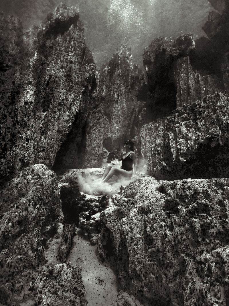 © Maddison Woollard - Landing | Inside the crater of an extinct volcano, cave-like pillars rule this underwater landscape
