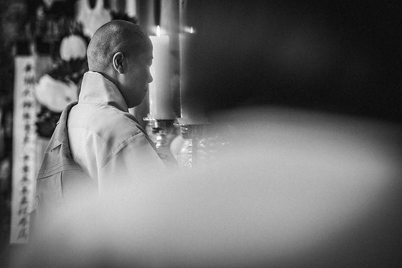 © Min A Choi - A Buddhist nun stands before a candle at the close of the rite. Jingwansa Temple, 2026.