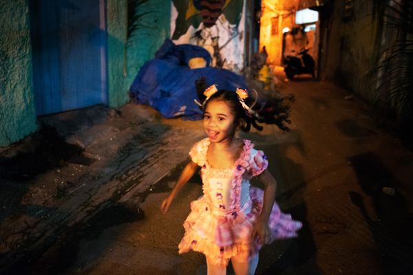 © Sabine van Wechem - Girl from the neighbourhood is running around through the alley during festina junina, an annual celebration day.
