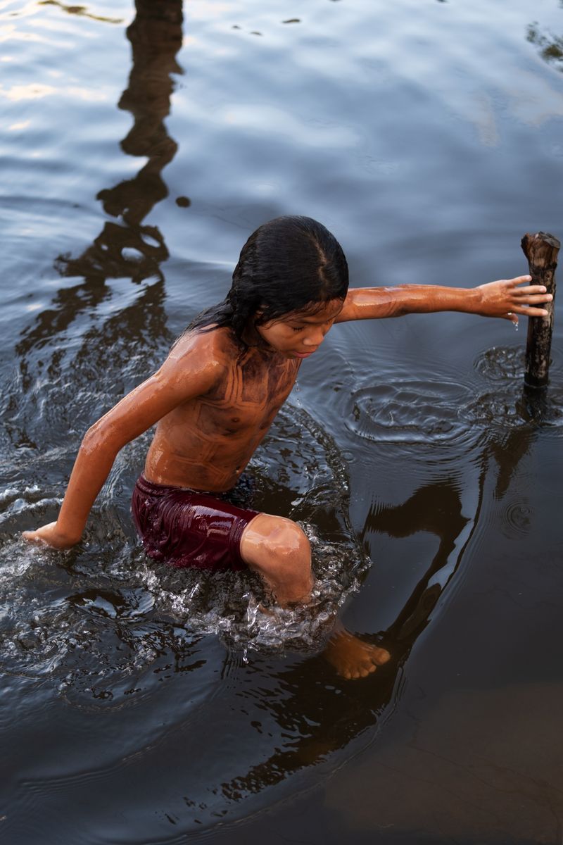 © Sabine van Wechem - A young kid plays in the river.