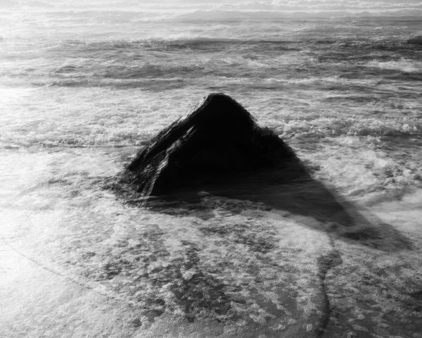 © Adam Thorman - 2026. VOID. Five images of a rock in waves layered over the top of each other.
