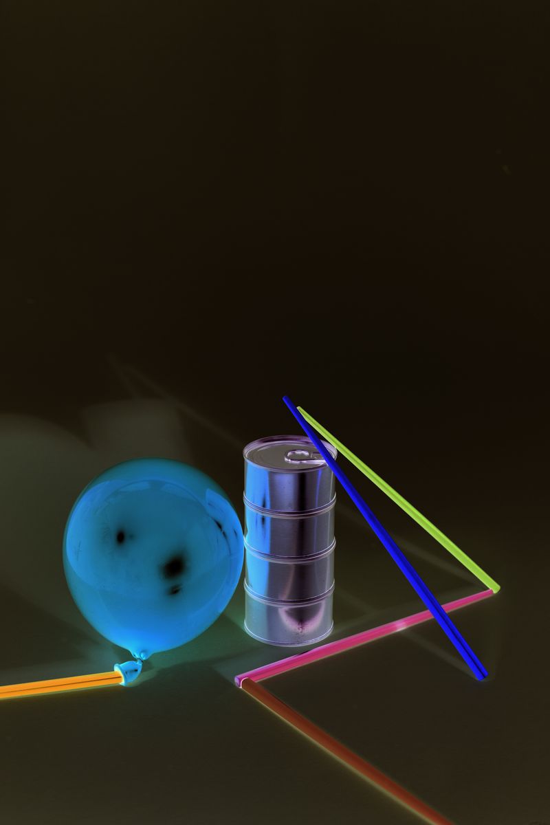 © Lucija Rosc - Composition made with five different-colored chopsticks, four tuna cans and a balloon.