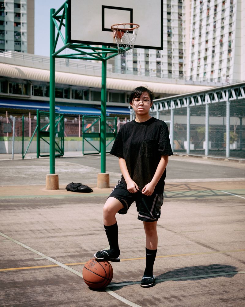 © Chung-wai Wong - Sese, playing basketball on her own, a basketball court in a public housing estate.