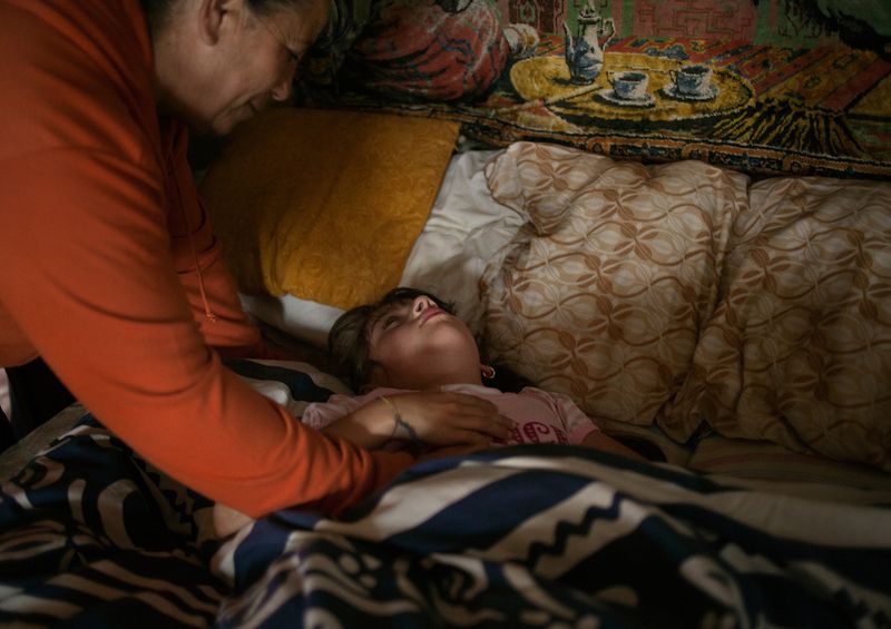 © Stefano Carini - 09/05/2012, Torino, Italy -- Sabina wakes Sabrina up early in the morning before getting ready for school.