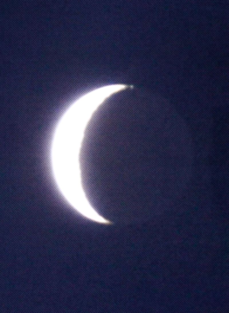© Emmaline Zanelli - A zoom photo of the crescent moon taken by Brayden* on a camcorder. 2023