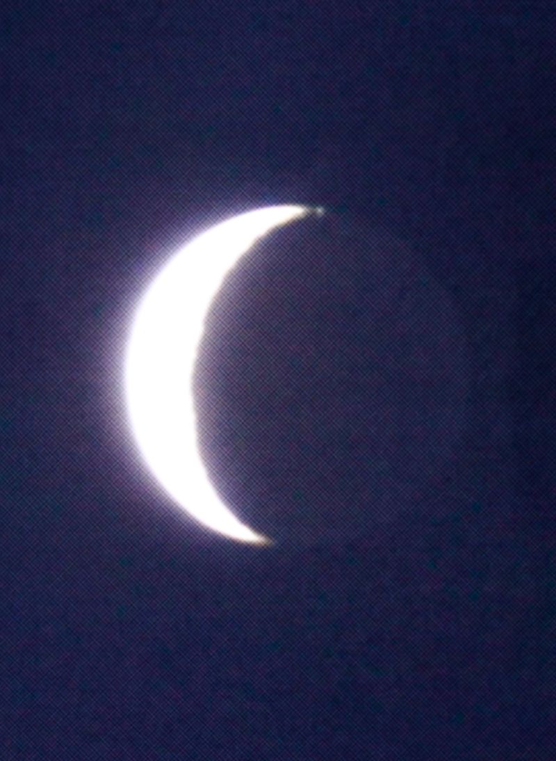 © Emmaline Zanelli - A zoom photo of the crescent moon taken by Brayden* on a camcorder. 2023