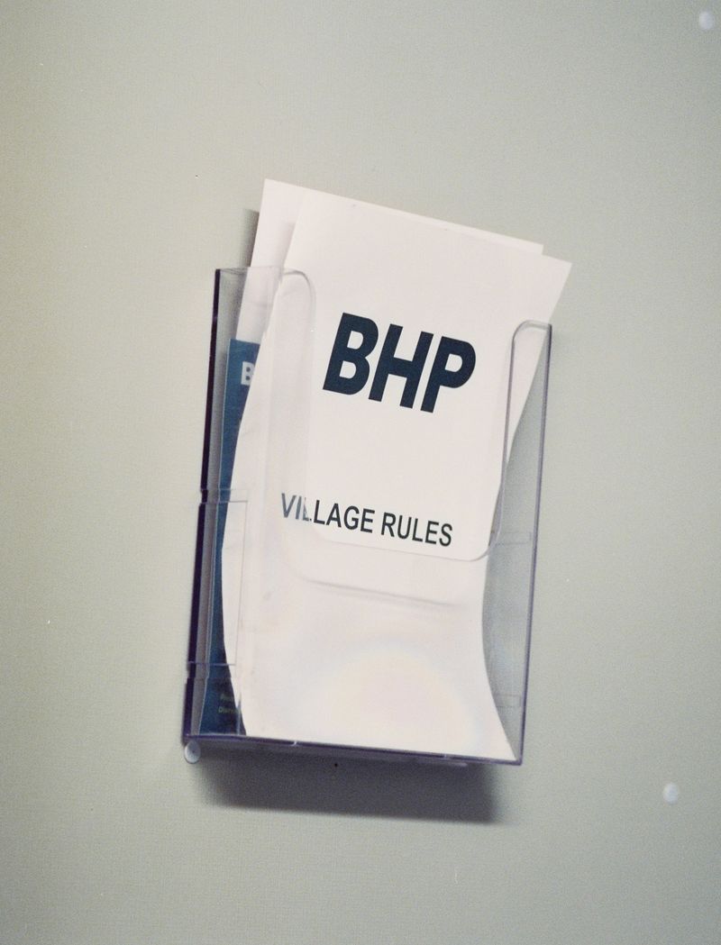 © Emmaline Zanelli - BHP Olympic Village mine camp rulebook sits on the wall in each worker's room. 2022