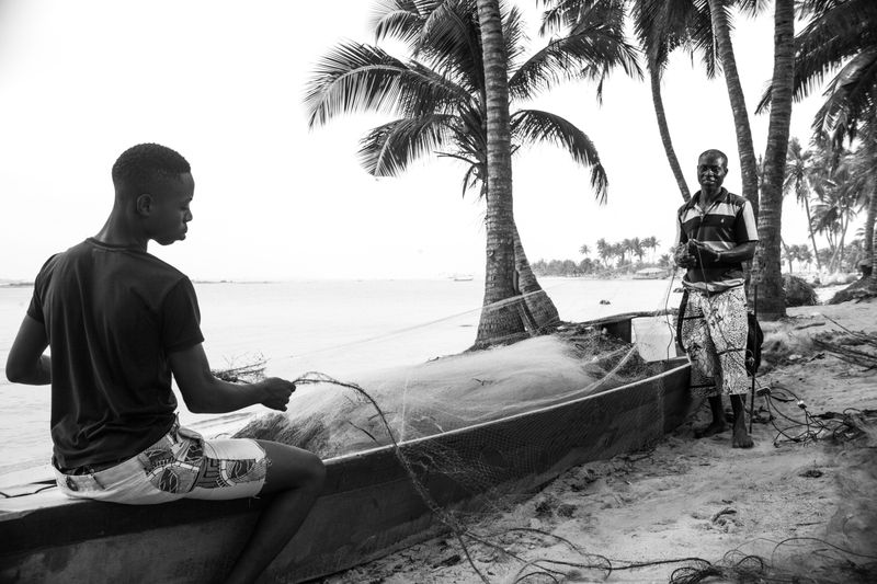 © Ofoe Amegavie - Father and son mending their fishing net, 2019