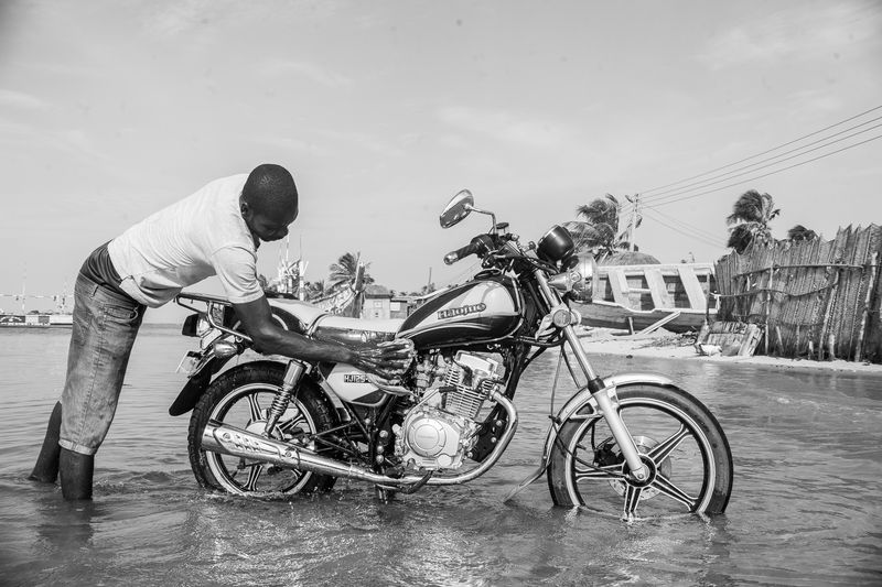 © Ofoe Amegavie - Man washing his motorbike in the Volta lake, 2020