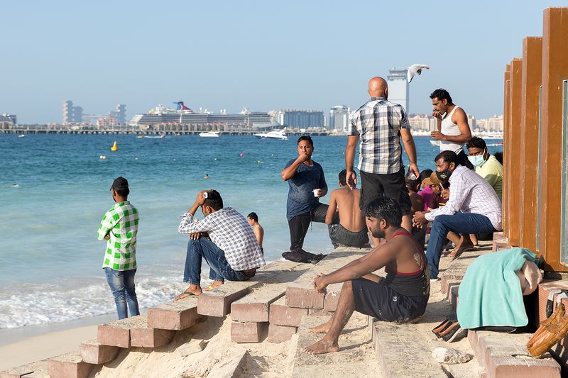 © Filippo Venturi - Beachgoers sitting in a small non-hotel-owned area overlooking the beach. Dubai Marina, Dubai, 2021.