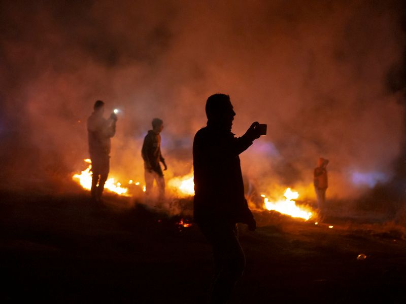 © Edith Geuppert - Residents of the village Susiya in the South Hebron Hills film settlers from a settlement nearby entering the village.