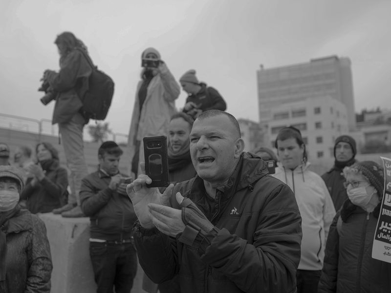 © Edith Geuppert - A Israeli Right wing activist is filming a demonstration in the East Jerusalem neighborhood Sheikh Jarrah.