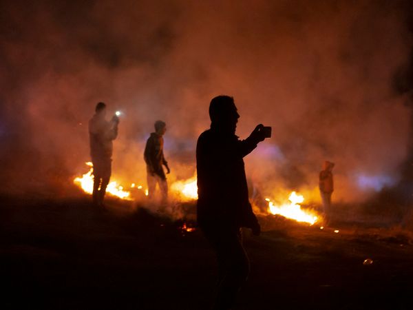 © Edith Geuppert - Residents of the village Susiya in the South Hebron Hills film settlers from a settlement nearby entering the village.
