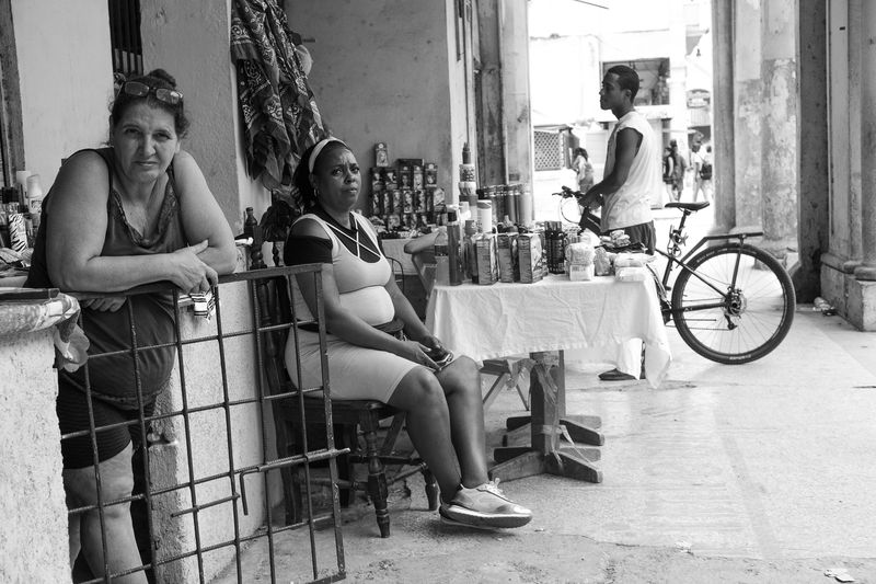 © Valentine Ollawa - Women selling goods in front of their home
