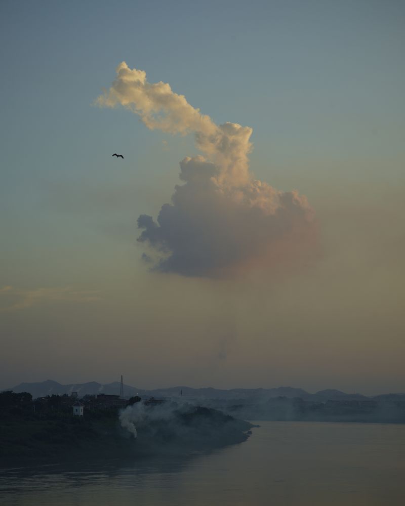 © YANG YANG - Colorful clouds on the Xijiang River.