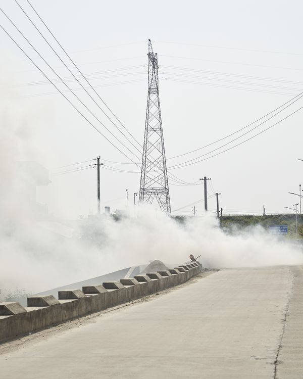 © YANG YANG - Smoke on the Xijiang flood control embankment.