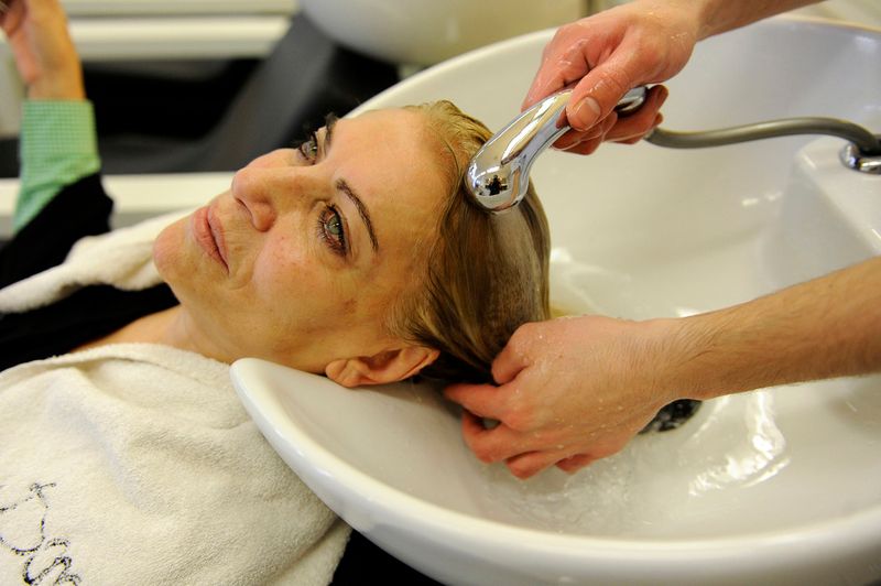 © Natalie Naccache - An elderly lady has her hair washed after it being dyed at Pace e Luce Salon in Beirut, Lebanon.