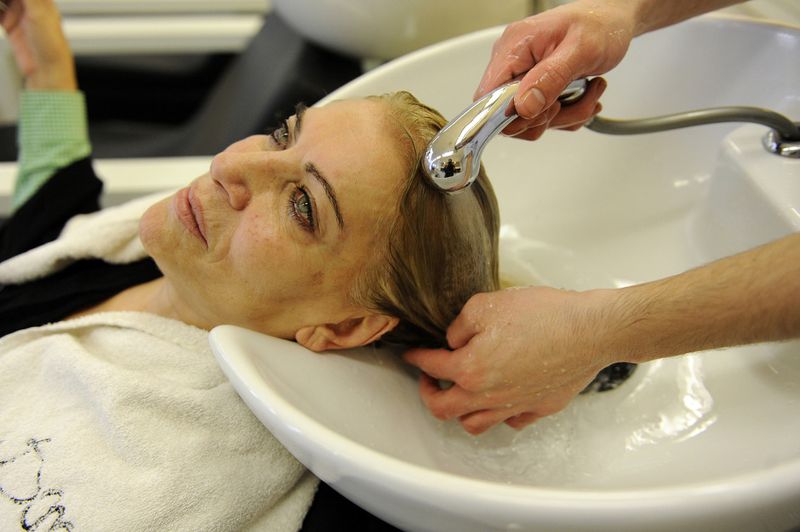 © Natalie Naccache - An elderly lady has her hair washed after it being dyed at Pace e Luce Salon in Beirut, Lebanon.