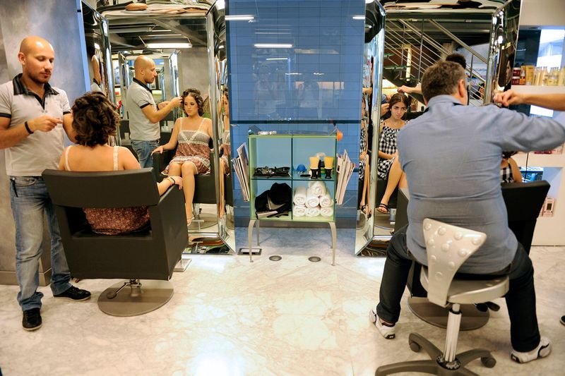 © Natalie Naccache - Nour, 18, and Carine, 18, have their hair groomed at a hair salon in Beirut in preparation for their high school prom.