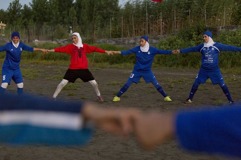 © Azadeh Besharati - The players were warming up to start their football game...