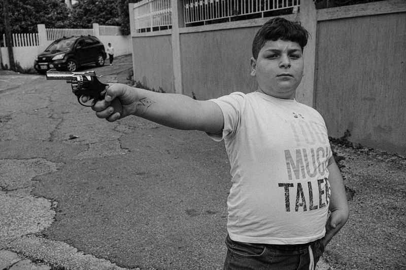 © Habib Saleh - A young boy holding a gun during times of war, Lebanon 2024.