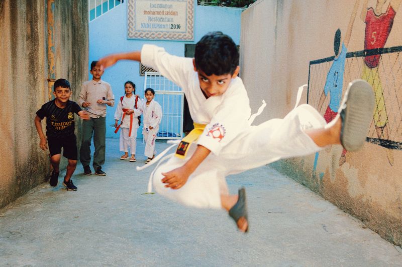 © Habib Saleh - A young kid is jumping off the ground, showing off his karate skills. Sidon City, Lebanon 2024.
