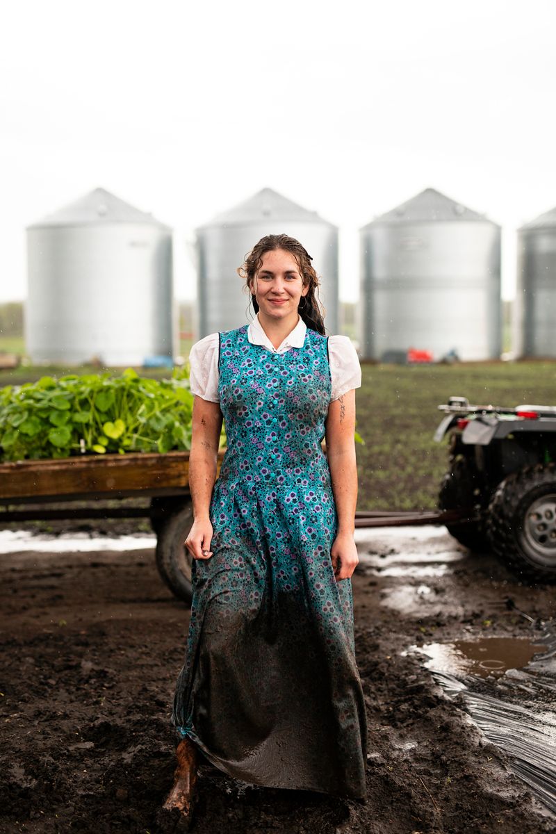 © Tim Smith - June 5, 2019 Bethany Hofer in Deerboine Colony's garden after planting cucumbers in the rain.
