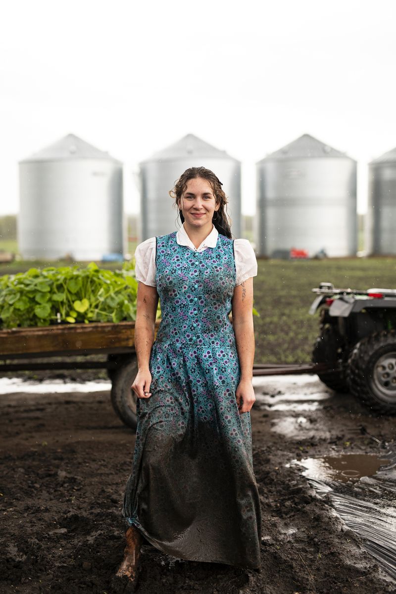 © Tim Smith - June 5, 2019 Bethany Hofer in Deerboine Colony's garden after planting cucumbers in the rain.