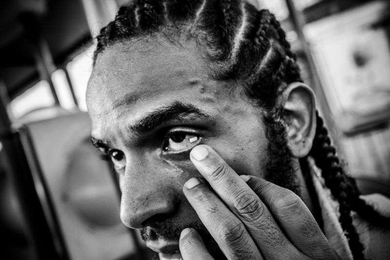 © Oscar B.  Castillo - Ray Martinez, Aka " El Niche" takes half a trip paper of LSD inside the eye at a party in the prison.