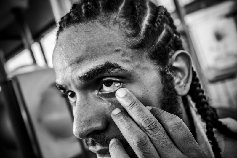 © Oscar B.  Castillo - Ray Martinez, Aka " El Niche" takes half a trip paper of LSD inside the eye at a party in the prison.