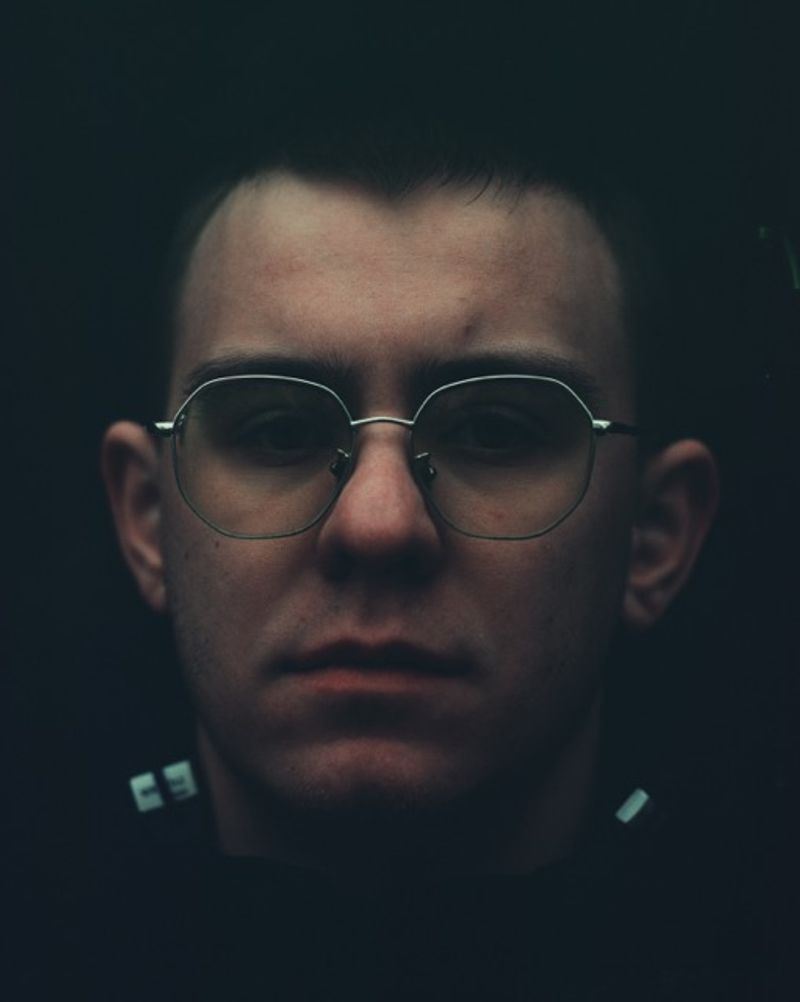© lucile brizard - Roman, a 23-years-old, stands outside his workplace in Kyiv. Kyiv, Ukraine, 2025