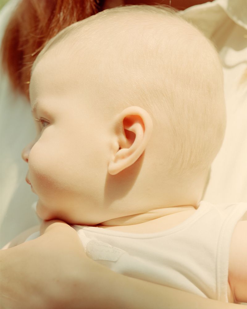 © Kata Geibl - The only real analogue photograph in the series. A Mother holding her Child.