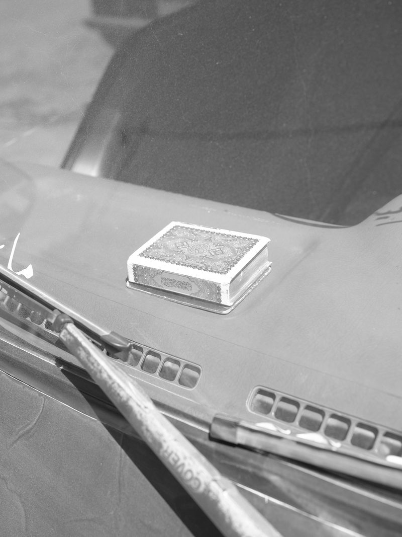 © Hamzeh Zahran - A Quran on a Dashboard, Amman, 2025, from the "Remains" series